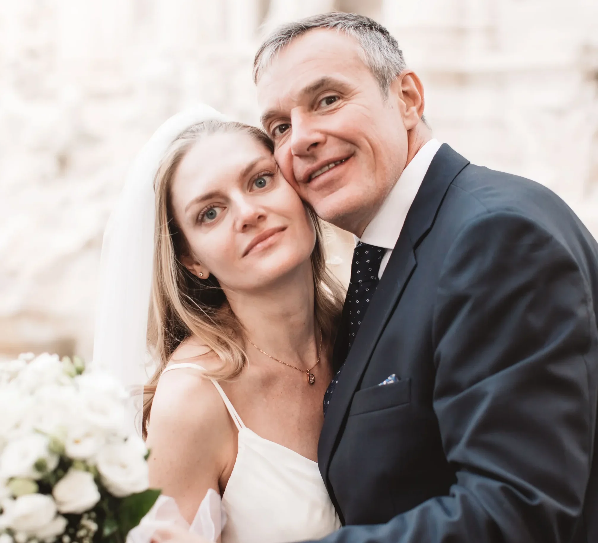 Russia bride and Ukrainian groom hugging after the civil wedding in Italy.