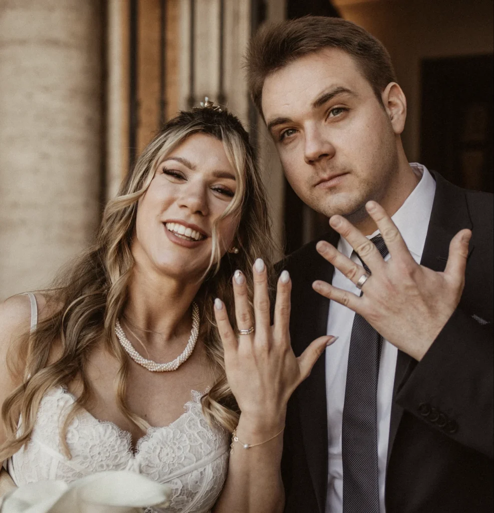 A couple showing their ring after a civil wedding in the Campidolgio in Rome.