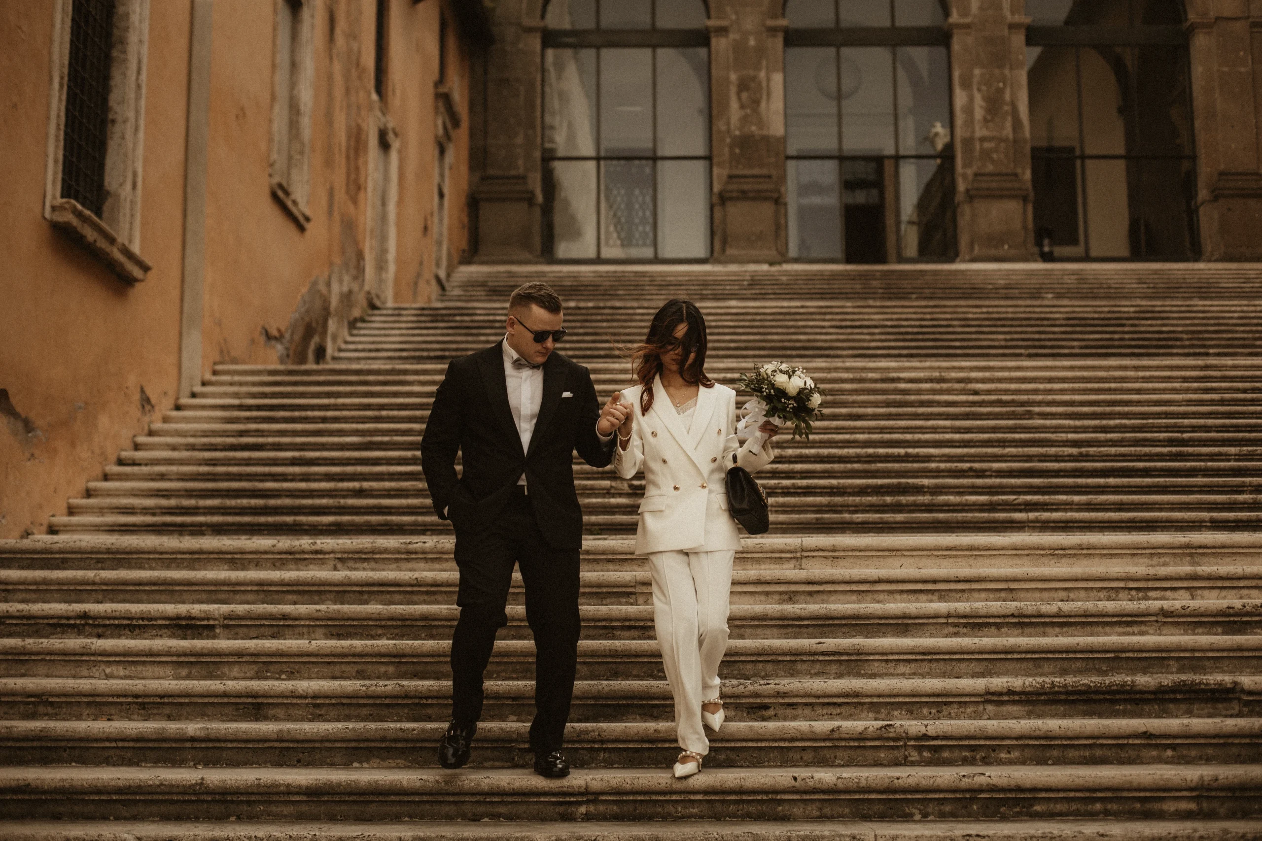 A Couple descending stairs after a Civil wedding at "Campidoglio" in Rome
