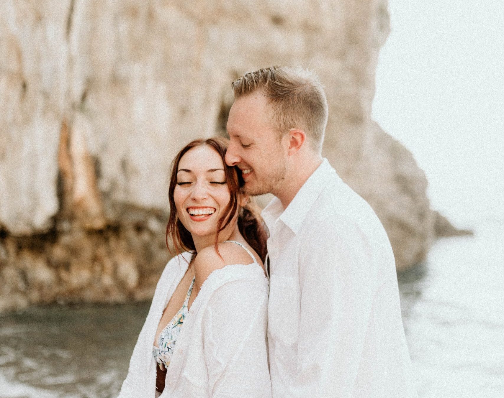 An American couple walking in a beach in the Amalfi coast after their wedding.