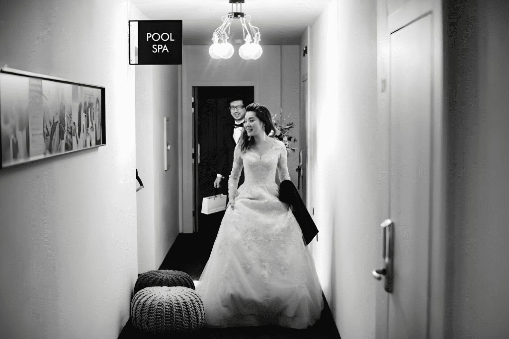 Japanese newlyweds posing in the corridor of Miramonti boutique hotel in Avelengo.